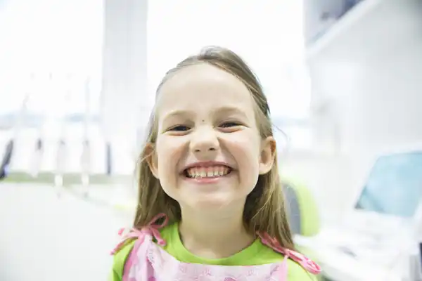 Smiling girl showing off her teeth at Sierra Kids Dentistry in Reno, NV